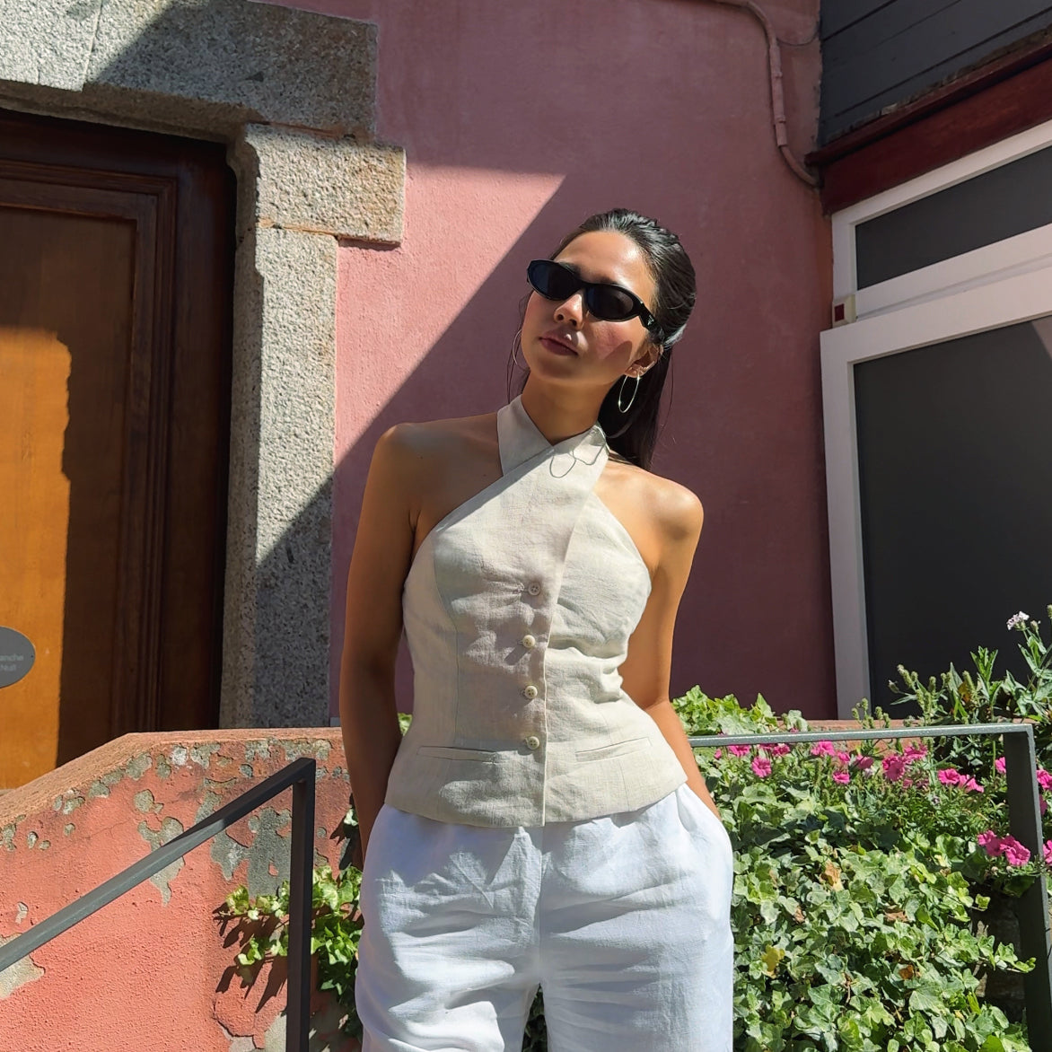 Beige linen Astrid Vest worn with white trousers