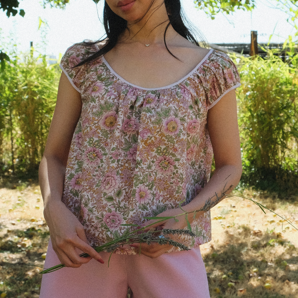 Close-up of the floral Linnea Blouse with bias-bound neckline