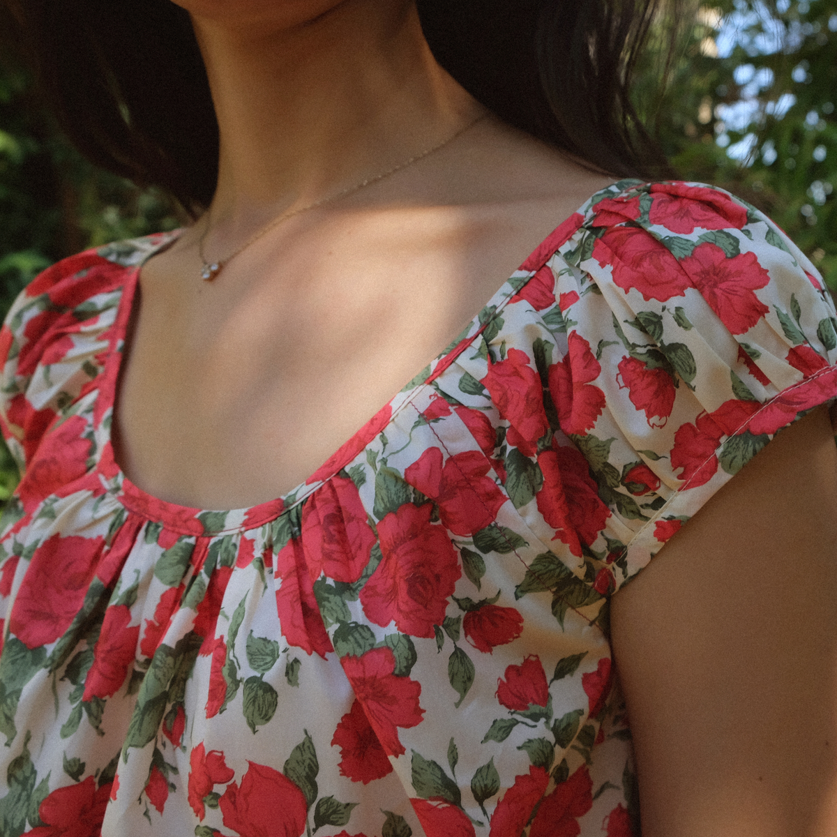Close-up of the Linnea Dress gathered scoop neckline in rose print