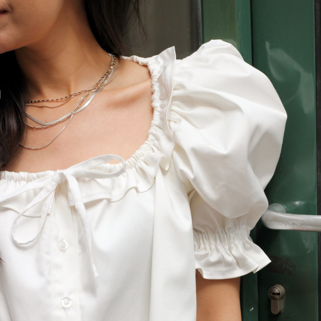 Close-up of the Mathilde ruffled neckline and tie