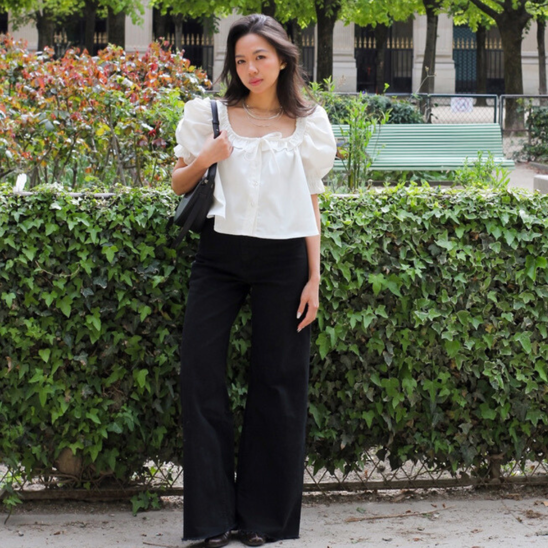 White Mathilde blouse styled with black wide-leg trousers