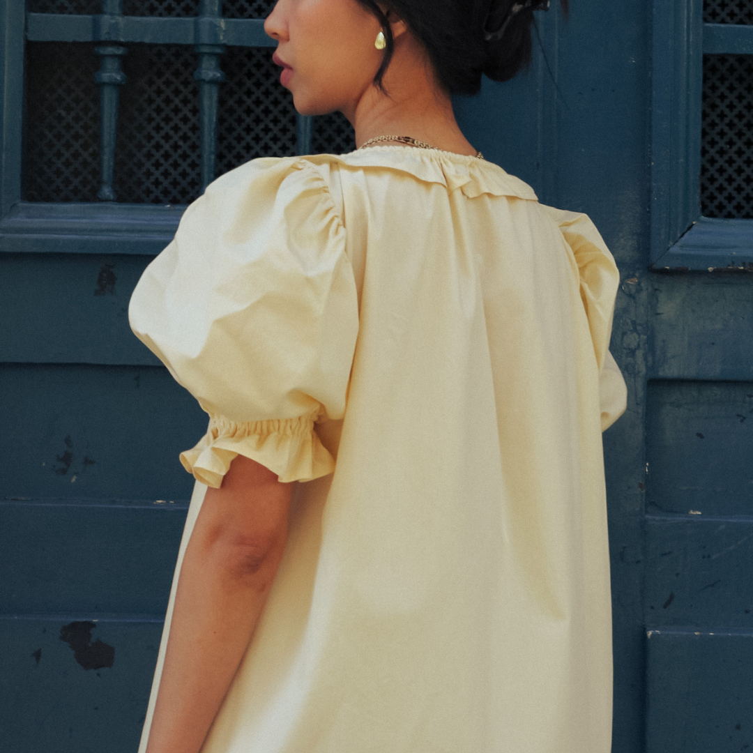 Back view of the pale yellow Mathilde babydoll dress