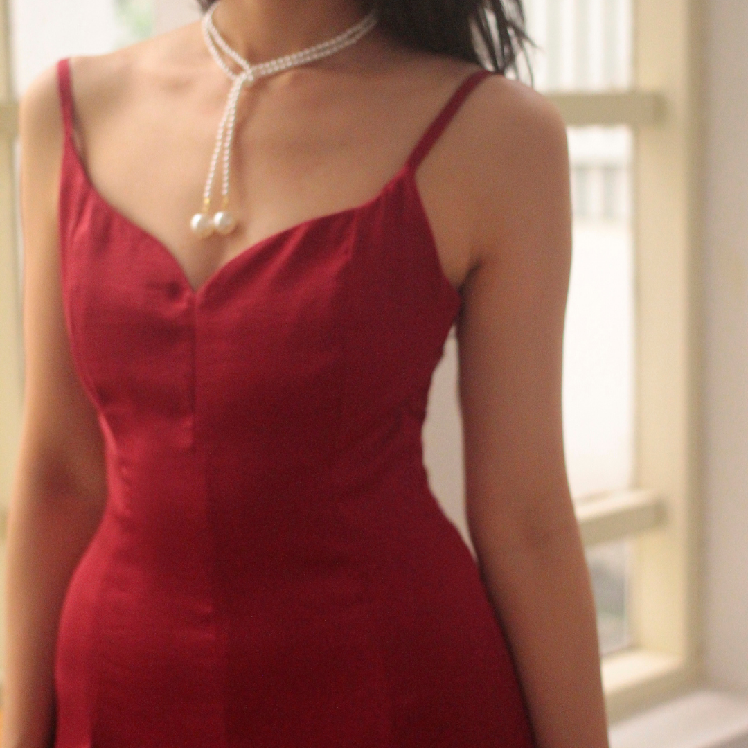 Close-up of the Rosa Kiss Dress sweetheart neckline in red