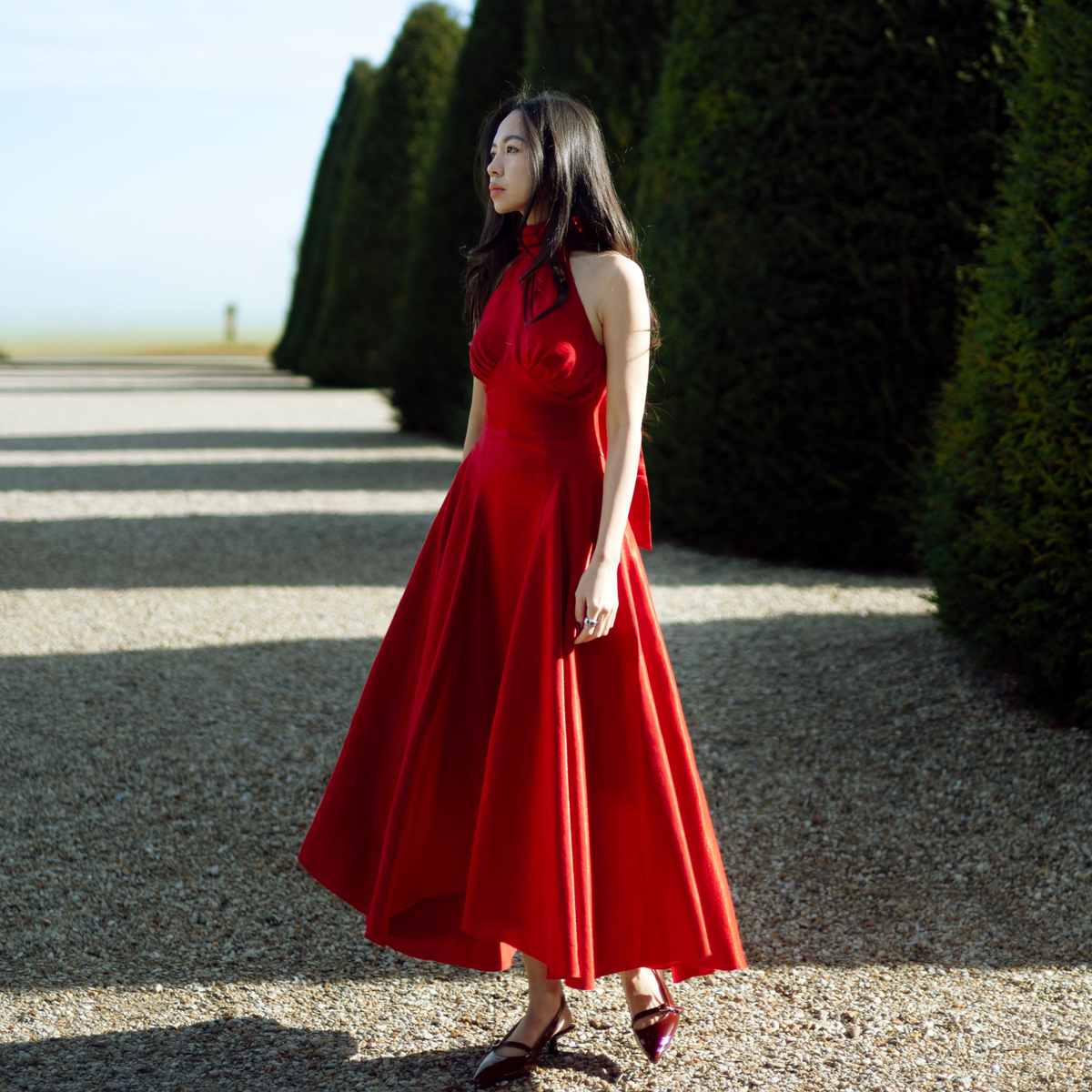Red Valentine halter neck midi dress in a garden