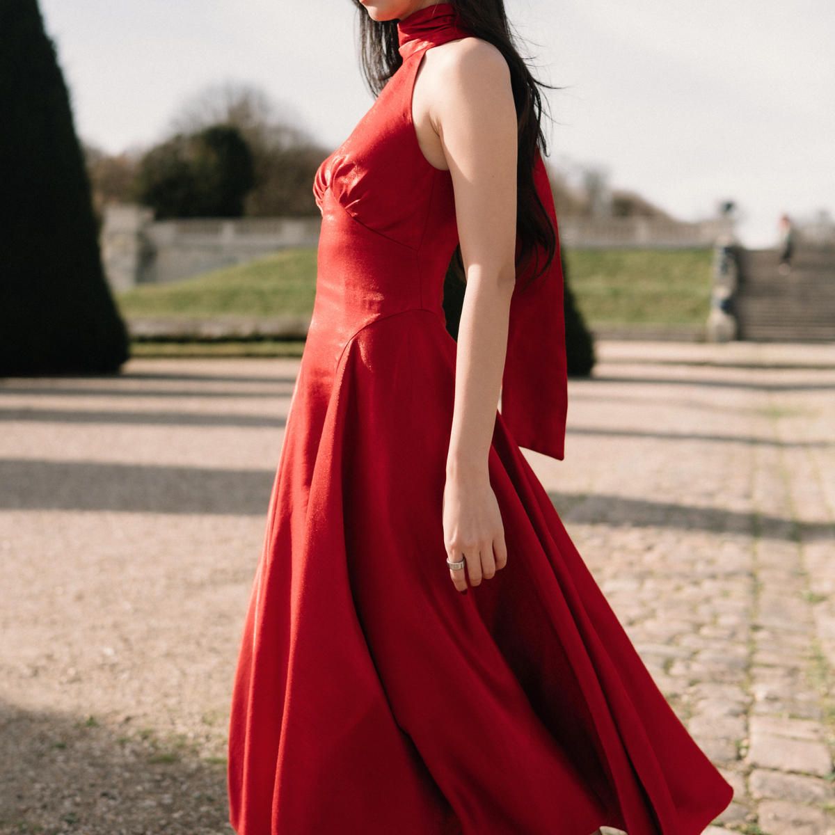 Side view of the red Valentine Dress with flowing half-circle panels