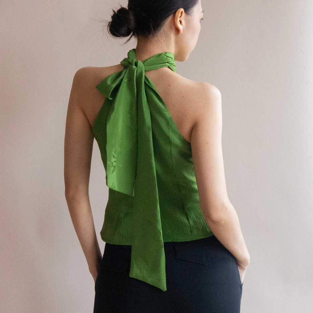 Back view of the green Valentine halter top with bow tie