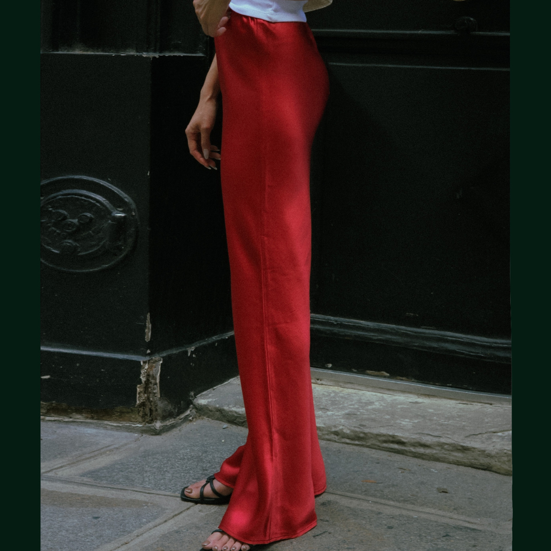 Side view of the red Vela bias-cut pants