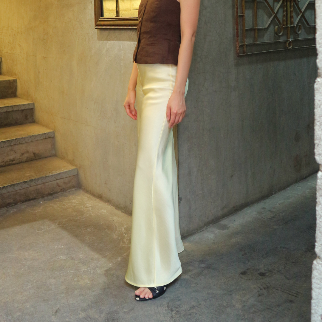 Side view of the cream Vela bias-cut pants
