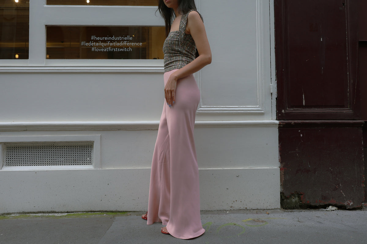 Side view of the pink Vela bias-cut pants